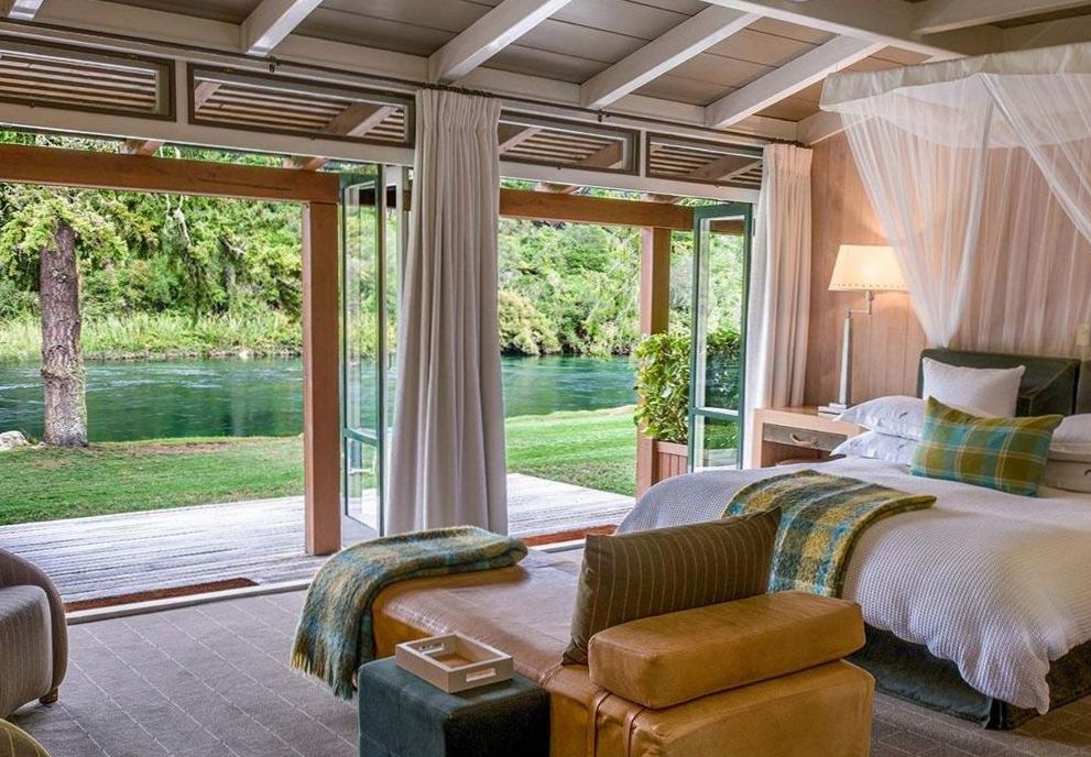 Premium Room with king bed, lounge chairs and warm timber panelling